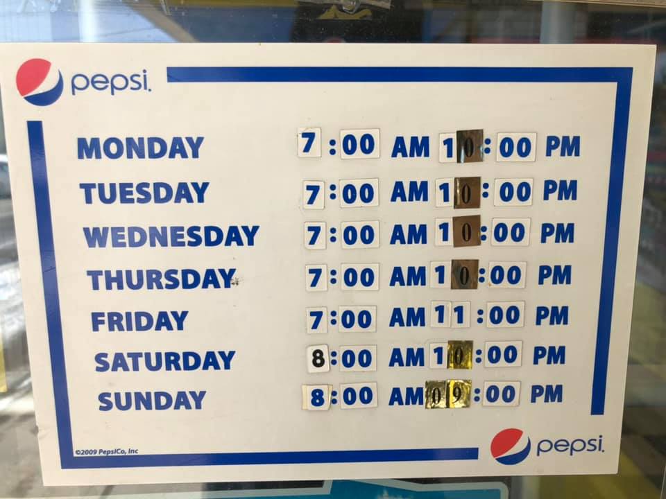 Store hours sign posted on the window