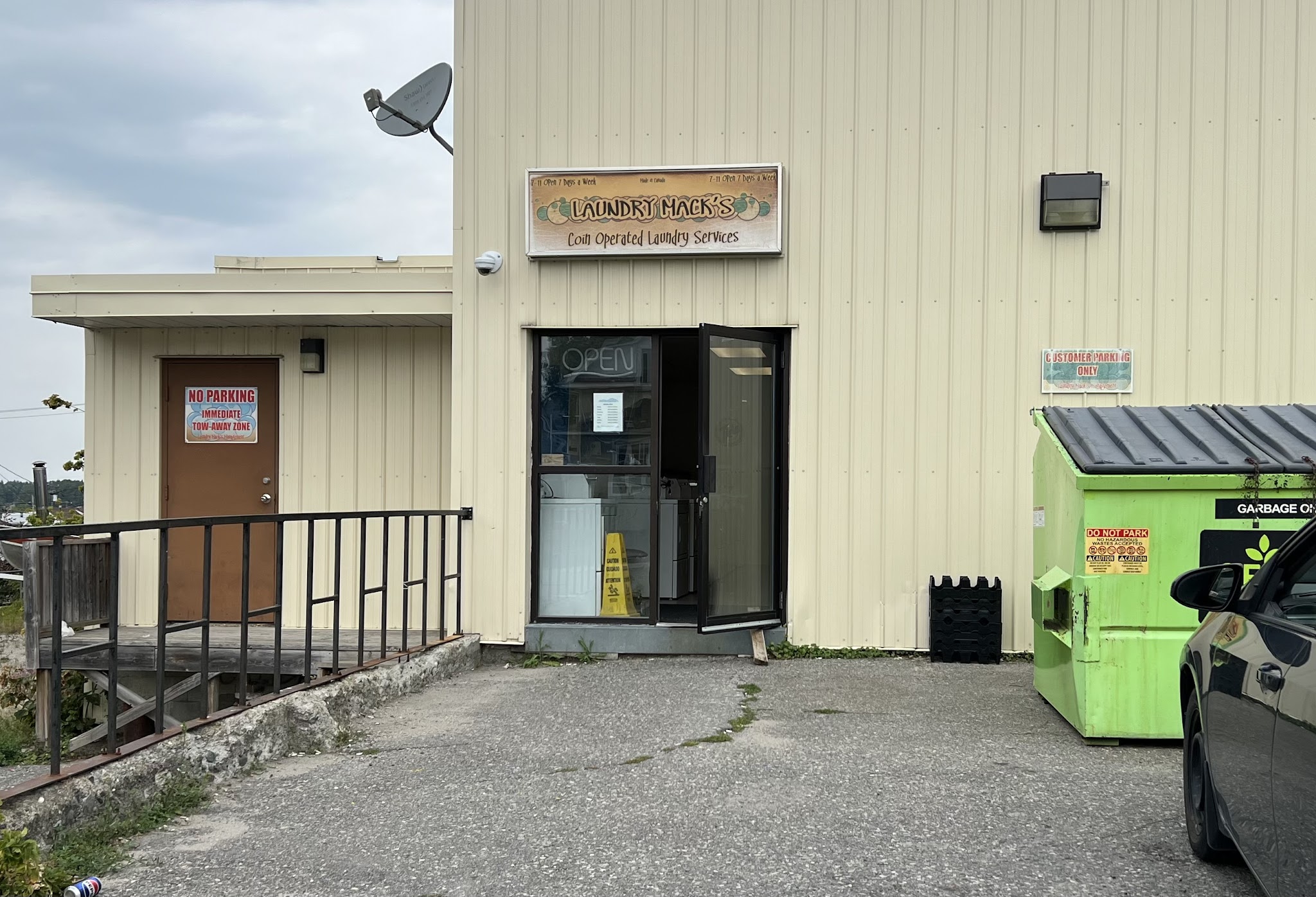 Laundry Mack's entrance showing the coin-operated laundry services sign